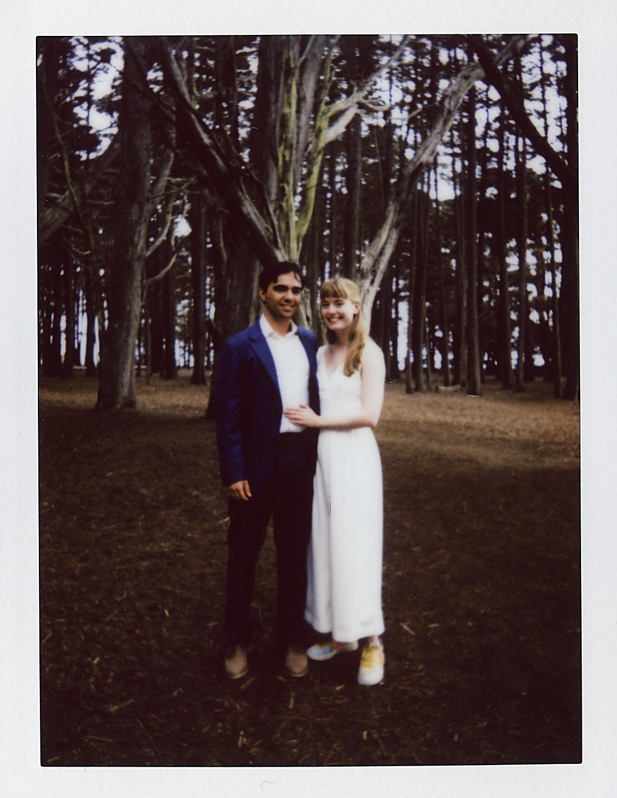 photo of husband and wife in a grove of trees